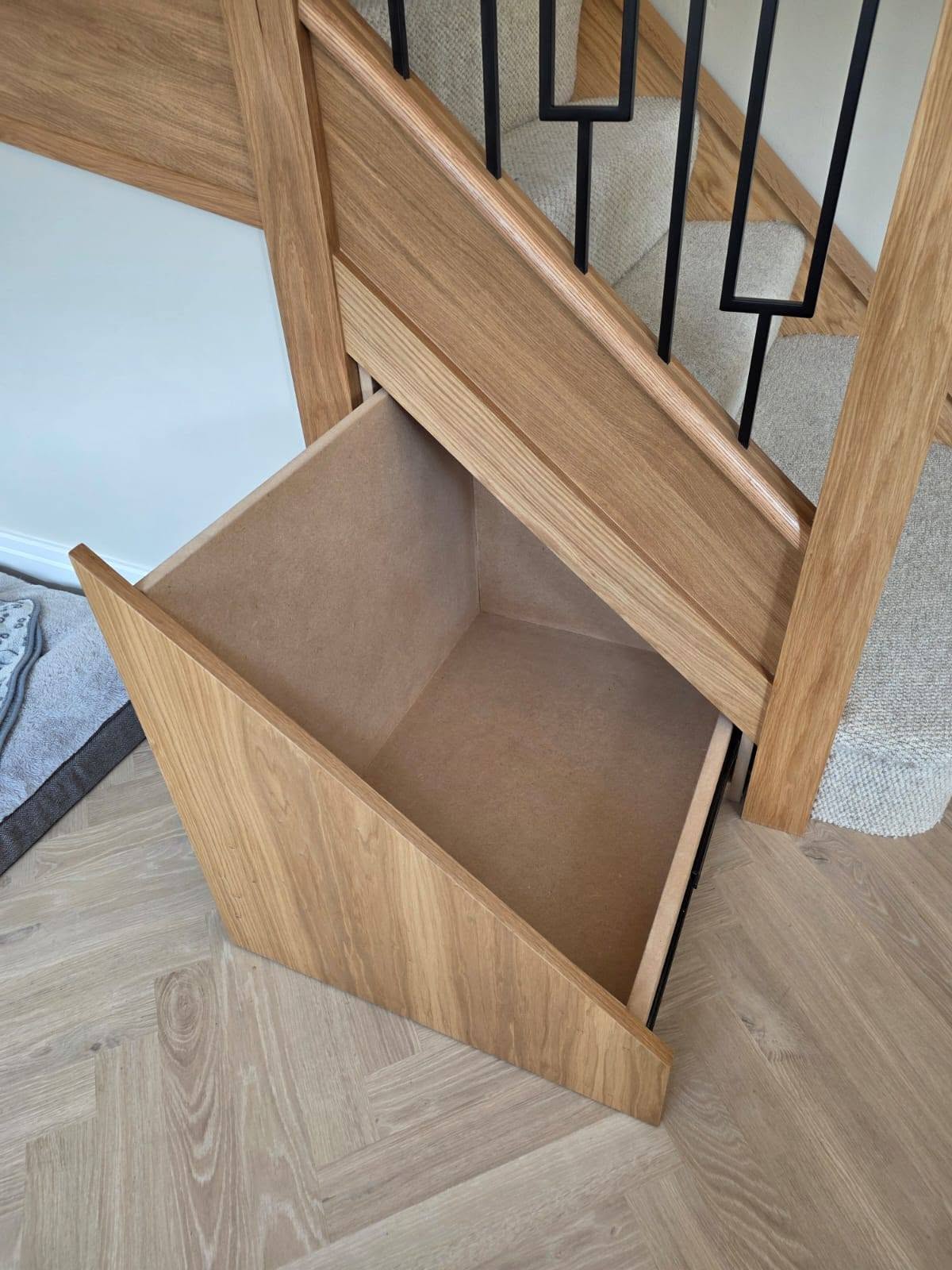 Bespoke fitted understairs storage by Elite making practical use of staircase space